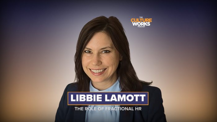 Headshot of Libbie Lamott for The Culture Works podcast, smiling with podcast logo in the background on the right side, wearing a blazer.
